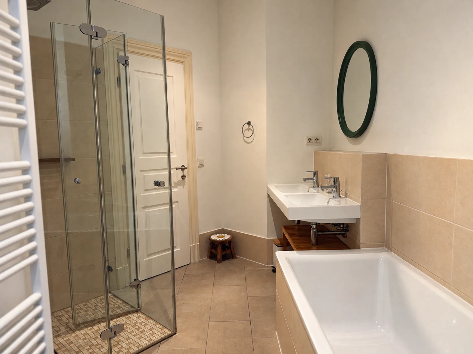 Bathroom with a bathtub, glass shower and double sink