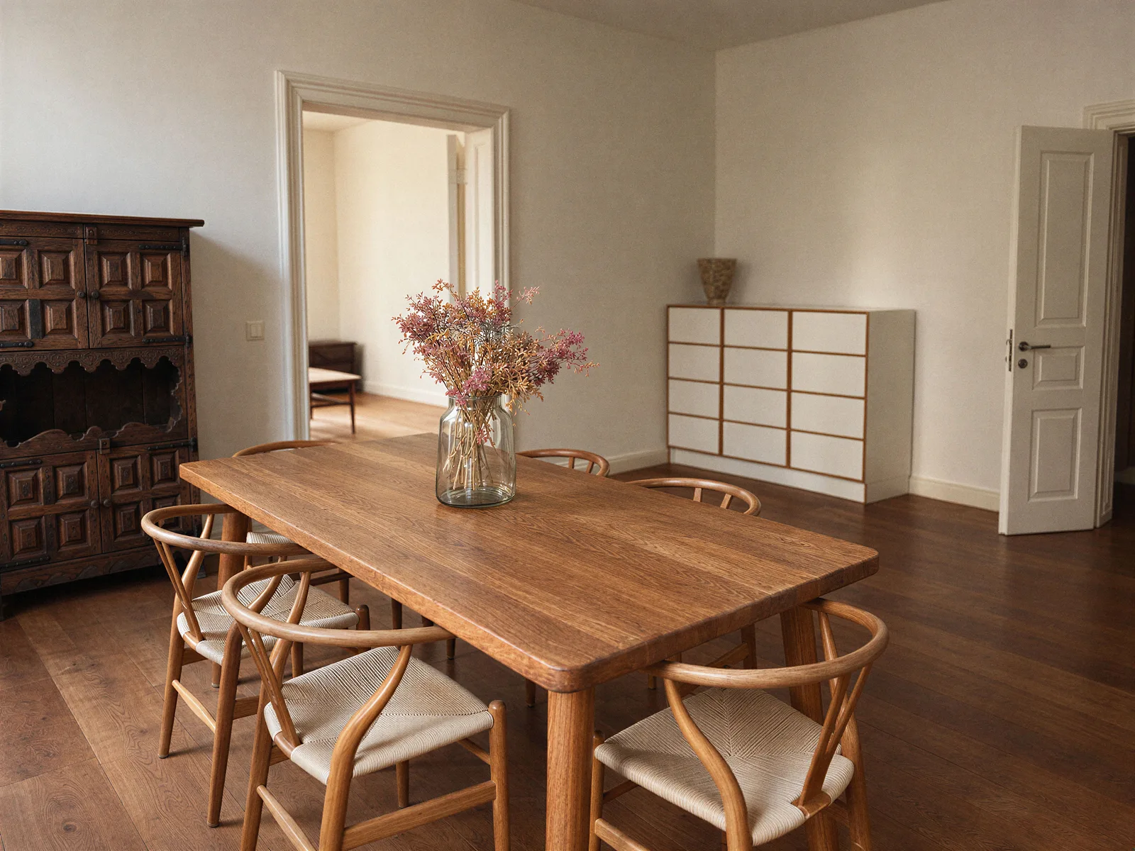 Wooden dining table and double doors to the living room